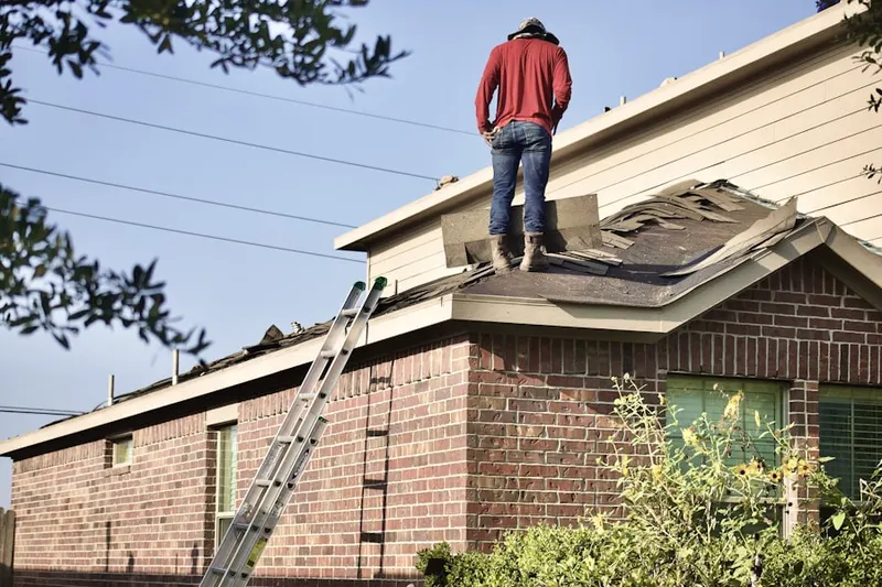 Professional roofer working on a residential roof in Blakely
